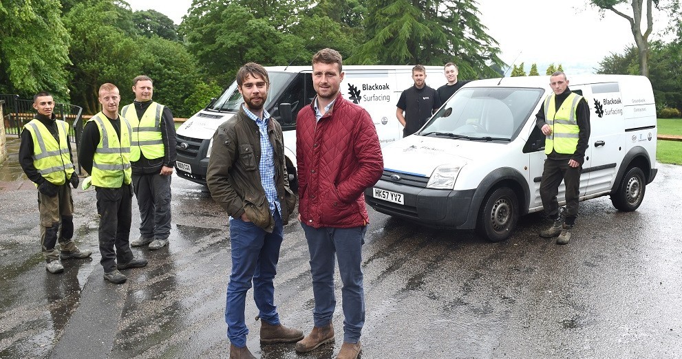 Front LR Thomas Jordan and Chris Whiteoak of Blackoak Surfacing in Nelson pictured with their team