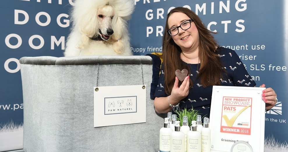 Angela Pinder with with her Poodle Dougal and her award winning products from Paw Naturel web