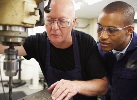 worker_teaching_apprentice_manufacturing_skills___web 2