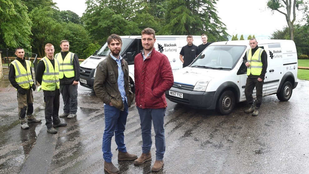 Front LR Thomas Jordan and Chris Whiteoak of Blackoak Surfacing in Nelson pictured with their team